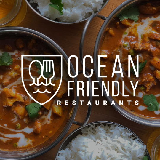 Ocean Friendly Restaurants logo overlayed on image of warm food in bowls